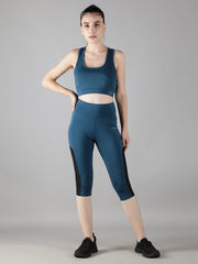 Model in Waylene's teal blue sports bra and capri track suit set, standing straight facing the camera. This image emphasizes the sleek design and comfortable fit, ideal for both sports and casual wear.