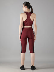 Rear view of a model in Waylene's wine track suit with Capri tights, highlighting the seamless stitching and snug fit.