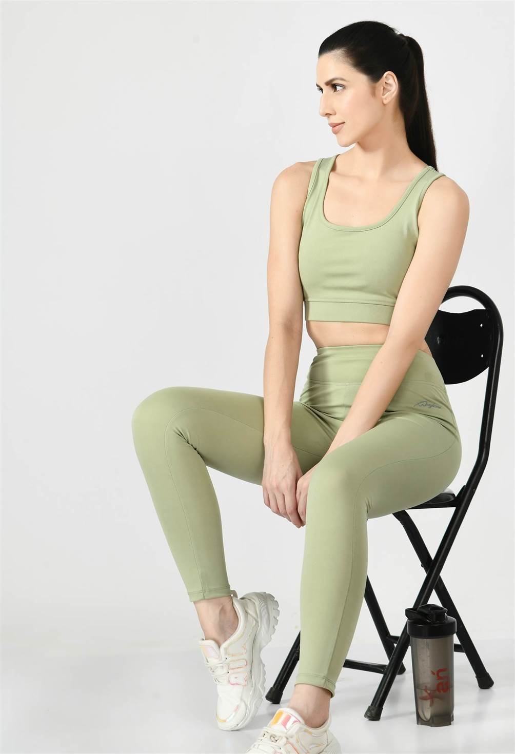 Waylene Pista Green Track Suit with Sleeveless Crop Top and High-Waisted Leggings, Seated Pose