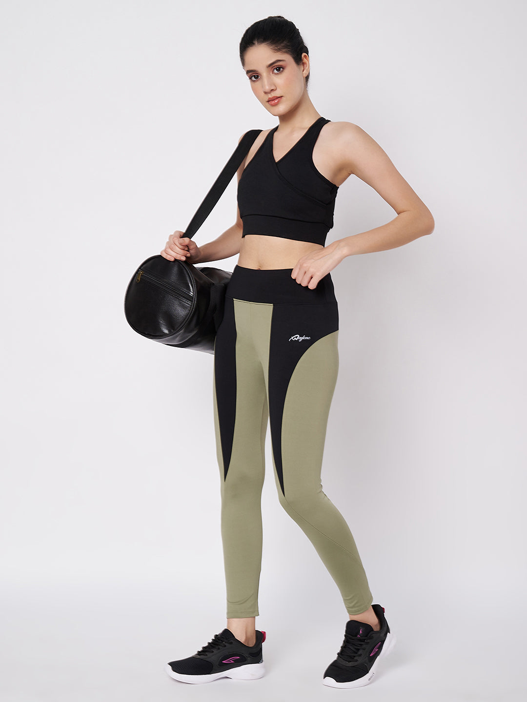 Waylene active leggings in olive green and black, styled with a black sports bra